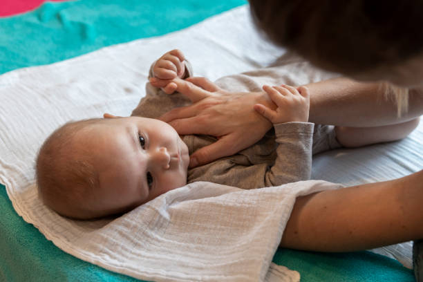 Baby is enjoying massage – gentle touche and soothing words.